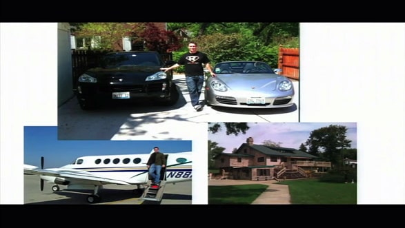 Ed O'keefe next to vehicles and a house